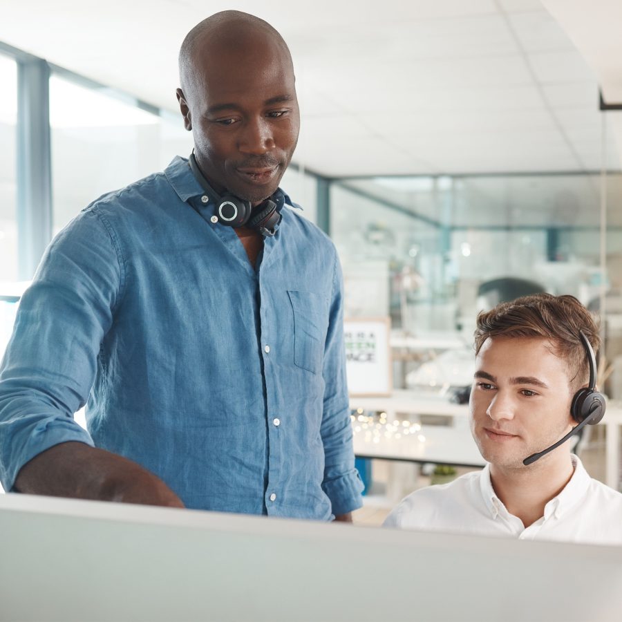 Man learning customer service training for telemarketing call center job, talking about crm and online support skills. Responding to contact us forms, questions and helping give customers good advice